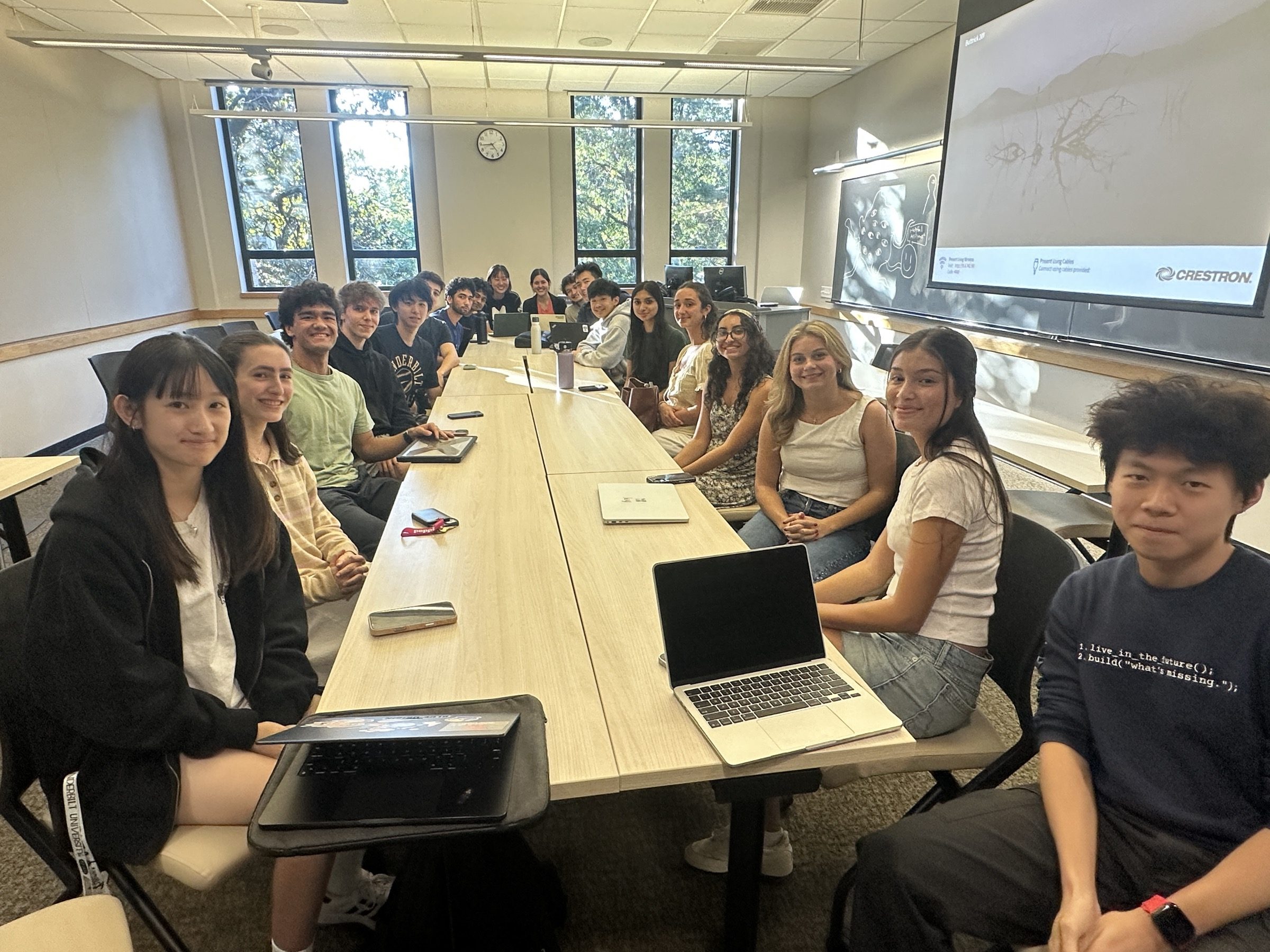 About twenty fellows seated around a long seminar table at the first fellowship meeting